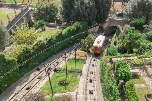 Upper city funicular line in Bergamo (Funicolare Citta Alta). Red funicular connects old Upper City and new. Scenic view of Bergamo historical center. Bergamo (upper town), ITALY - October 5, 2019