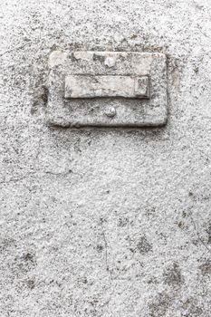 Broken doorbell, covered in paint, on a grungy wall with cracks and molds. Ideal for creative backgrounds.