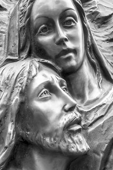 Mother Mary holding her son Jesus. Black and white portrait.