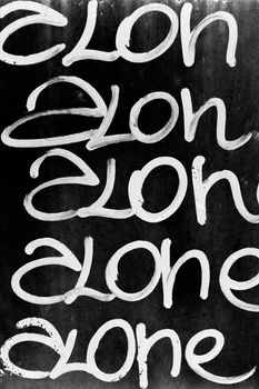 Word "alone" written on black grungy wall. It can be used as a poster, wallpaper, design t-shirts and more.