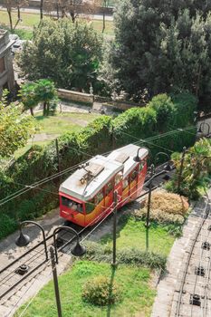 Upper city funicular line in Bergamo (Funicolare Citta Alta). Red funicular connects old Upper City and new. Scenic view of Bergamo historical center. Bergamo (upper town), ITALY - October 5, 2019