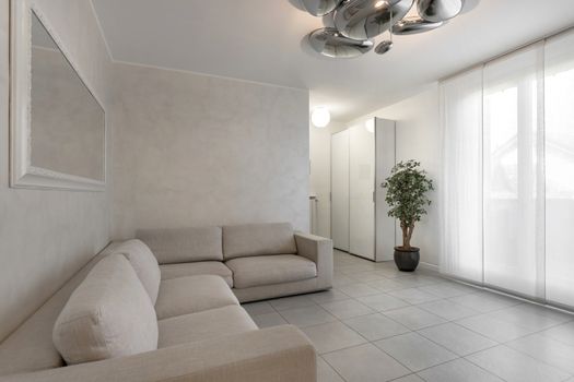 Italian interior design. Stylish living room in white color with sofa.