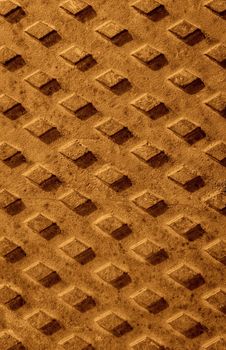 Grunge rusted drain cover background with diamond pattern