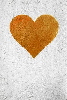 Orange rusty love heart hand drawn on grungy wall. Textured background trendy street style. Copy space.