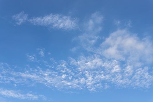 The vast blue sky with fluffy white clouds. Ideal for texture and background.