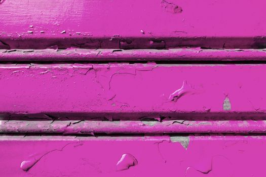 Background of old metal sheet with peel paint texture surface. Painted metal roller shutters door with peeling paint dirty violet hue. Grungy background texture.