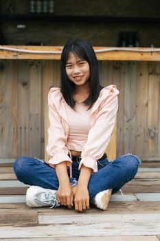 Portrait of asian happy woman smiling with wooden bridge, Selective focus