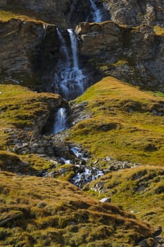 A small mountain stream flows down the mountainside