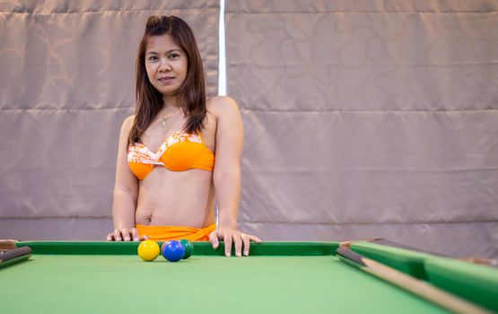 Portraits of Asian women in bikini swimsuits with snooker tables.