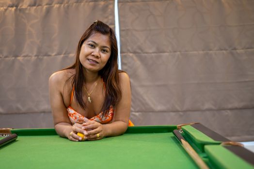 Portraits of Asian women in bikini swimsuits with snooker tables.