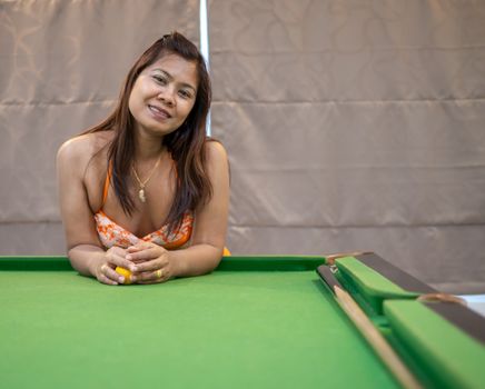 Portraits of Asian women in bikini swimsuits with snooker tables.