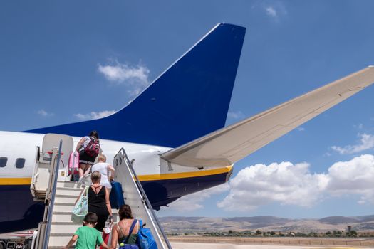 People board a plane. Airplane Boarding. Passengers climb the ladder.