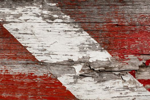 Close - up of wooden panel with red signs to prevent danger or accident. Detail of a wall prohibiting access to a construction site.