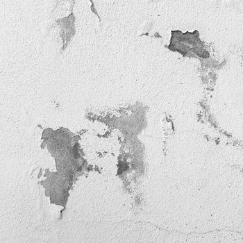 Cracked wall. Paint white peeling off an old interior wall. Ideal for concepts and backgrounds.