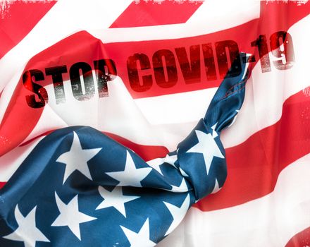 American flag with knot and message Stop COVID-19. Outbreak and lockdown. Concept of stop working activities due to coronavirus medical emergency.