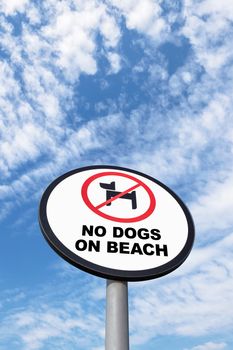 No dogs allowed sign on sky background. Dogs are not allowed on the beach at all times.