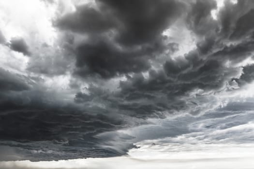 Supercell thunderstorm. Dramatic black clouds and motion. Dark sky with thunderstorm before rainy.