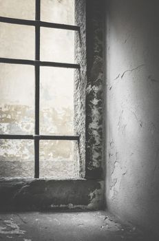 Vintage window of an old weathered building. Retro style photo.