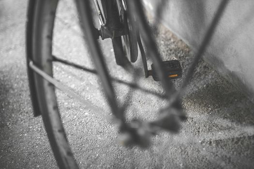 Vintage bicycle wheel. Part of old urban bicycle wheel. Retro style photo. Shallow depth of field.