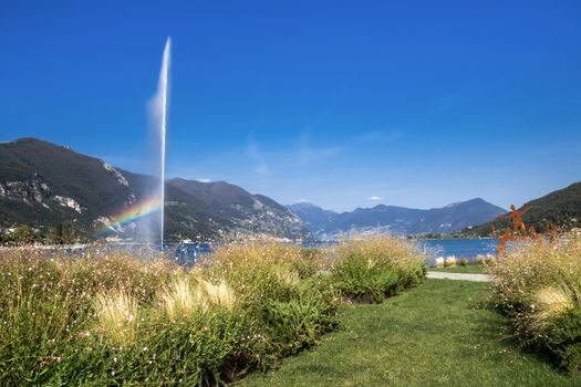 Paratico and Sarnico on the Lago d'Iseo. City promenade. Landscape of the lake with art installations of gardening and jet fountain. Paratico (BS), ITALY - August 21, 2013.