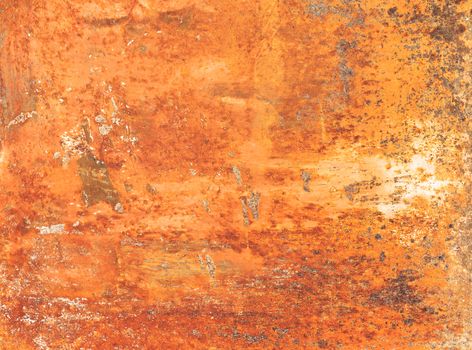 Rusty textured metal background. Grunge orange panel with oxidized or rusty marks produce a colorful painted surface that is full of texture and patterns.