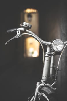 Vintage bicycle leaning against a wall. Retro style photo.