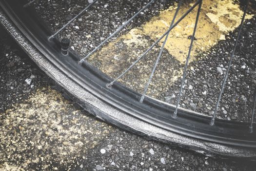 Closeup view of bicycle flat tire on pavement. Flat tire bicycle. Bike with a flat tire.