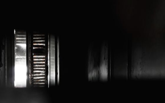 Old window with dirty light view. Sunlight entering through the window of an old house creating a creepy ambience.