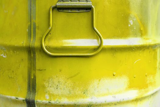 Yellow color can. Metal can with yellow paint drips.