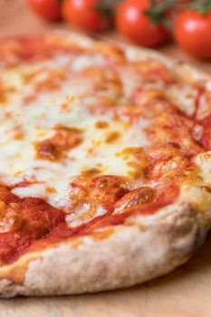 Vertical closeup shot of an italian pizza margherita with tomato souce and mozzarella di bufala cheese