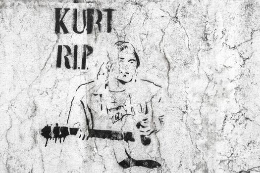 Kurt Cobain character. Graffiti / stencil on grungy wall. Bergamo, ITALY - May 20, 2019.