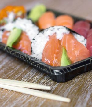 Japanese seafood sushi. Closeup of fresh sushi on rustic wooden table. Shallow DOF.