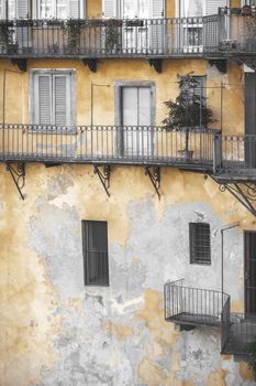 Grunge facade. Colorful and decadent residential building in Europe, Italy.