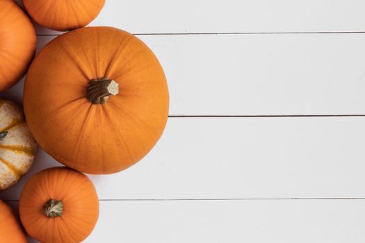 Many orange pumpkins on wooden background , Halloween concept , top view with copy space