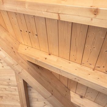 Wooden ceiling with exposed beams. Interior wooden roof with exposed beams.