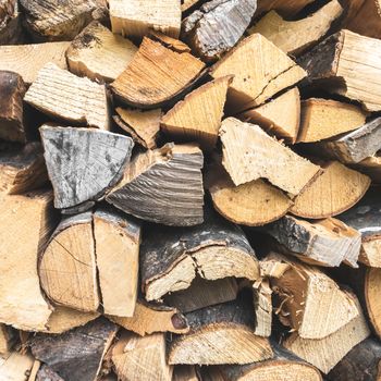 Firewood background. Stacked firewood in preparation for winter. Dry wood.