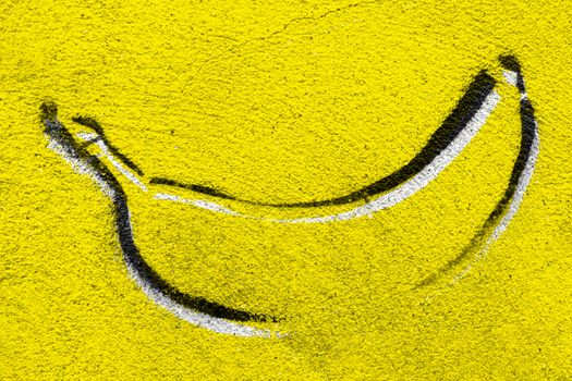 Banana graffiti on concrete wall. Backround with copy space.