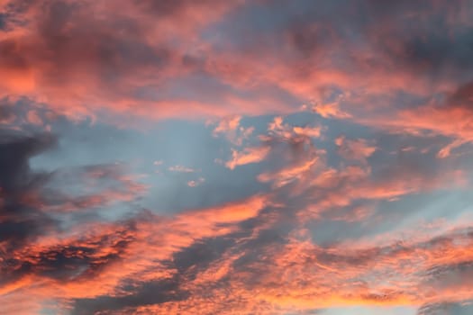 Beautiful panorama of orange and yellow clouds at sunrise and sunset in a blue sky