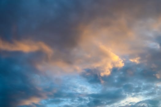 Beautiful panorama of orange and yellow clouds at sunrise and sunset in a blue sky