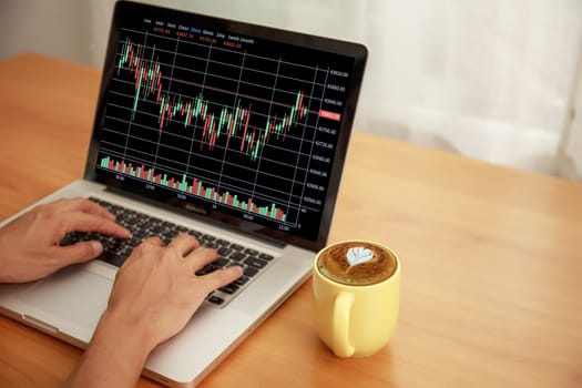 Business and technology concept Businessman hands with laptop and candlestick chart background. Businessman hands use computer network control trade buy and sell stock market with copy space.