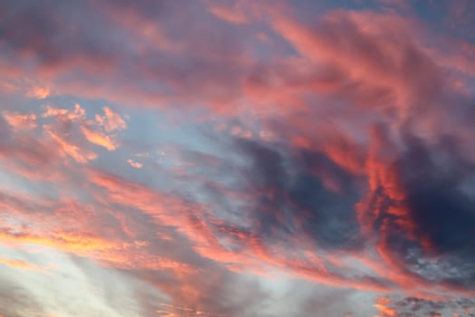 Beautiful panorama of orange and yellow clouds at sunrise and sunset in a blue sky