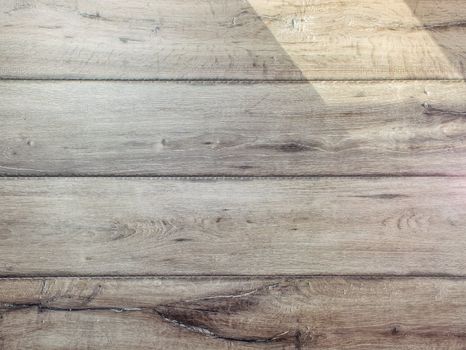 Texture of gray wood floor lit by sun