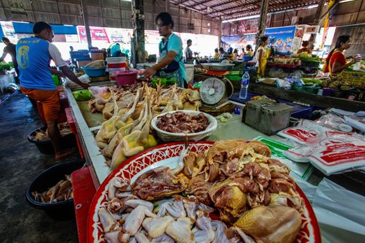 Khao Lak, Thailand - February 22, 2016:  Variety of fresh chicken legs, meat and bowels offered on local market in the morning when it's busiest.