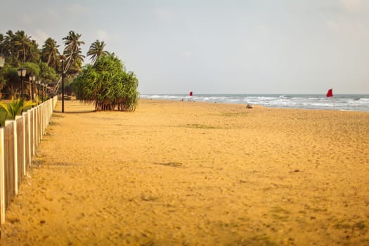 Quiet empty beach on afternoon sun. Kalutara, Sri Lanka