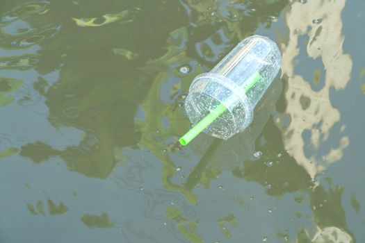 Plastic glass of bubble milk tea was left floating in the river