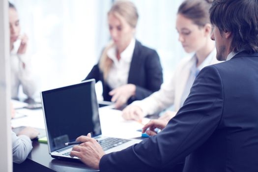 Business people with laptop at meeting in office