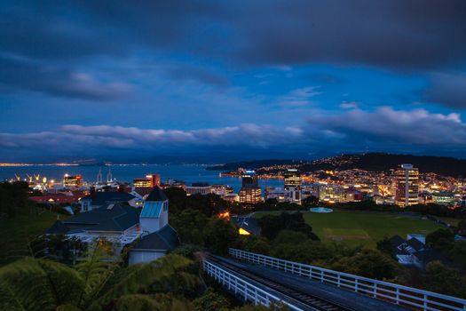View over Wellington skyline and harbour at dusk from near Carter Observatory and Cable Car in Wellington, New Zealand