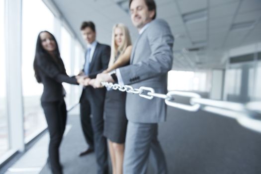 Businessmen pulling chain, teamwork togetherness concept