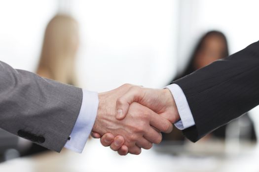 Close-up of handshake of businessmen on meeting in office