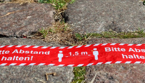 Bitte Abstand Halten! 1.5 meter social distancing sign for COVID-19. Keep distance symbol in german language